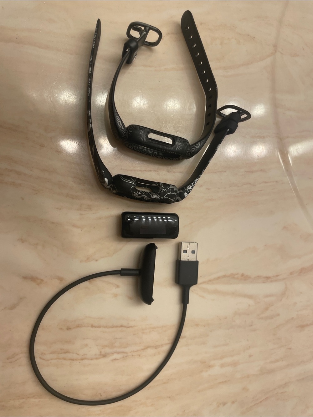 Black kids fitbit with charger and two watch bands